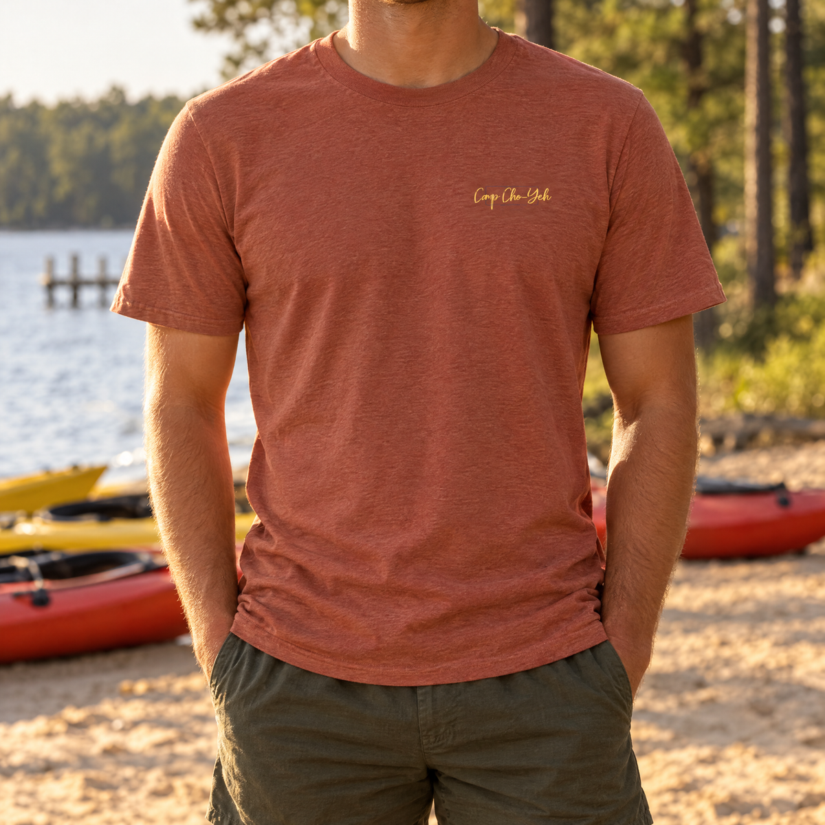 Kayak Lake Tee in Heather Clay, front left-chest script, worn on the lake shore at Camp Cho-Yeh