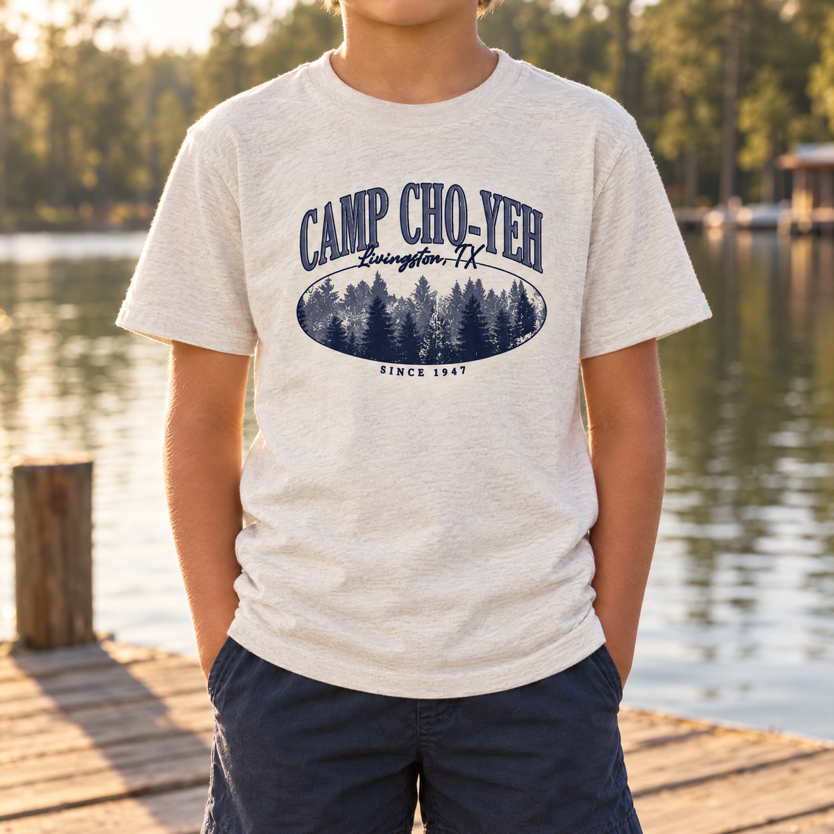 Camp Cho-Yeh Pines Youth Tee in Heather Dust, front print, worn on the dock at Camp Cho-Yeh