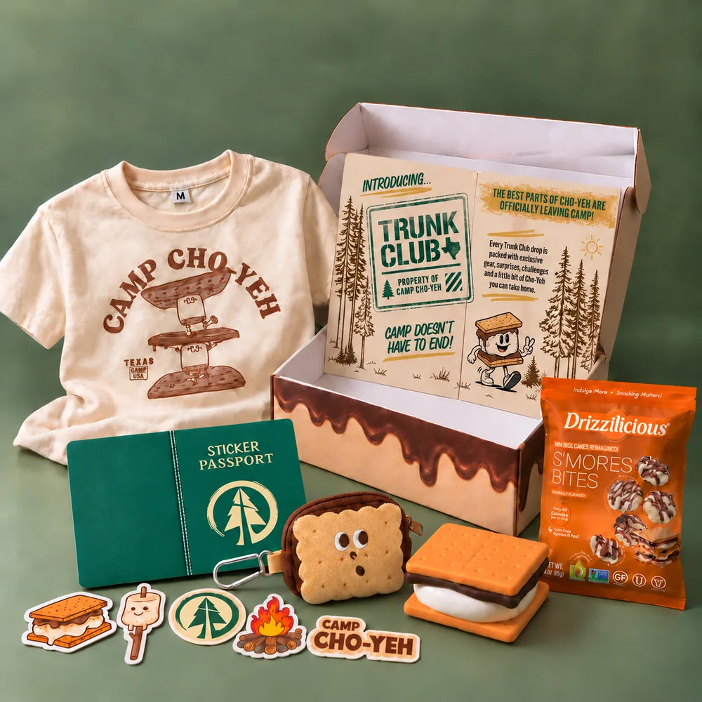 Everything in Trunk 001 laid out: the Camp Cho-Yeh tee, sticker passport, sticker pack, S'mores Travel Pal, peel-apart squishee, S'mores Bites and the printed insert